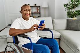 Woman in wheelchair happily using her phone